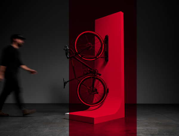 Bike on stand against a dark background with a person walking by