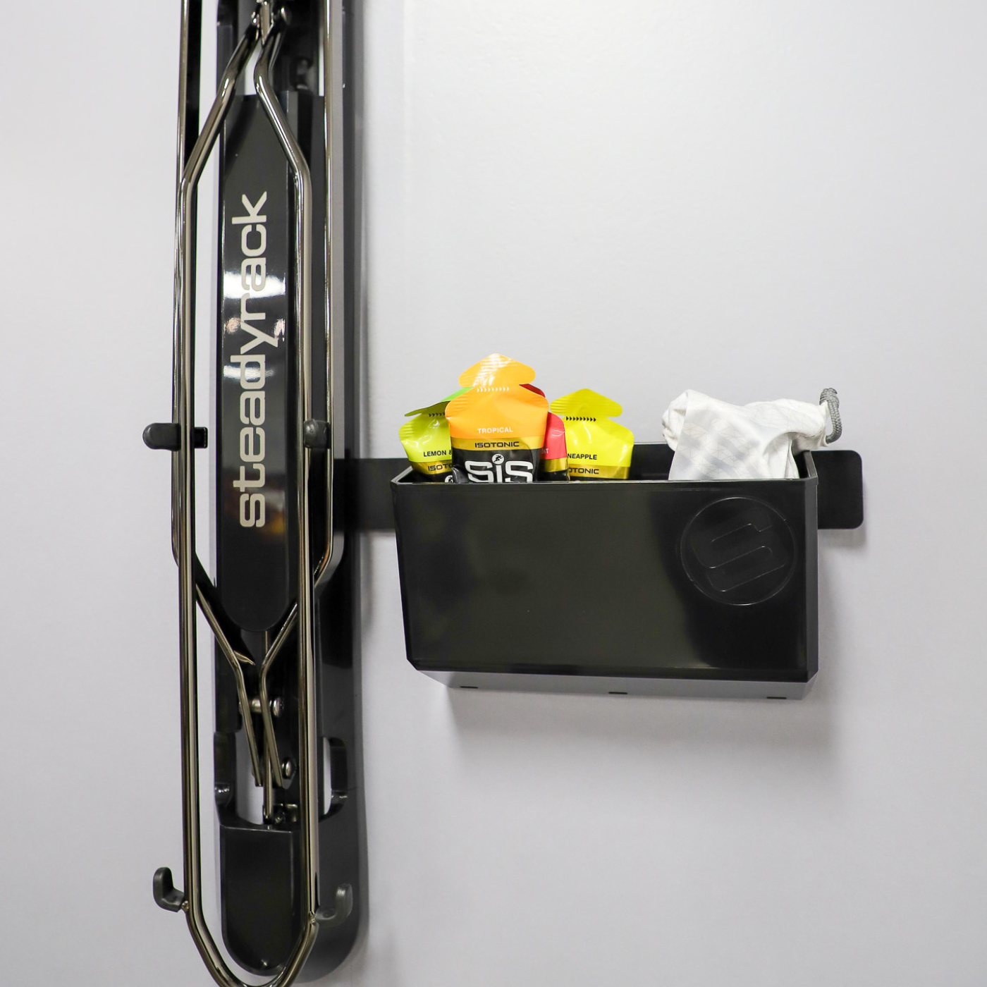 The GearMate Large Steady Bin storing a sunglasses in a case and energy gels. 