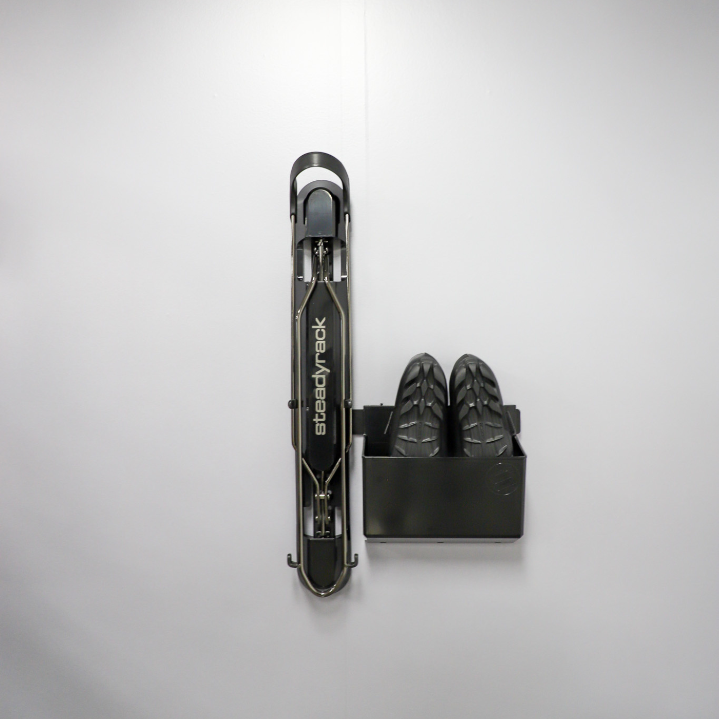 A ProFlex Rack with the GearMate SteadyBin attached storing a pair of cycling shoes. 