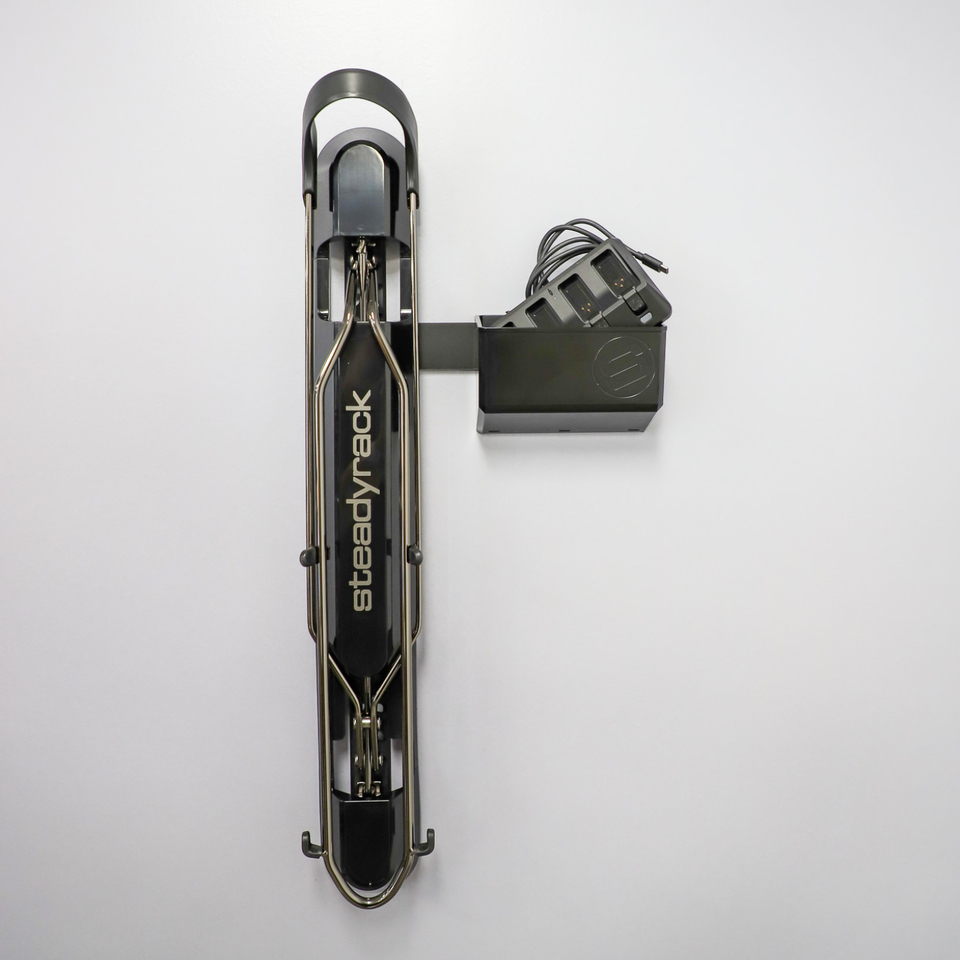 A ProFlex Rack with the GearMate SteadyBin attached storing an electric bike charger. 